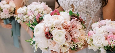 Decorative floral arrangements in woven baskets on a table outdoors.