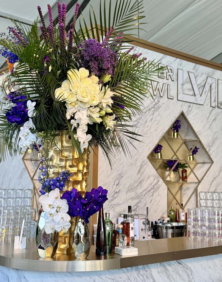Decorative floral arrangement on a bar counter with a modern interior background