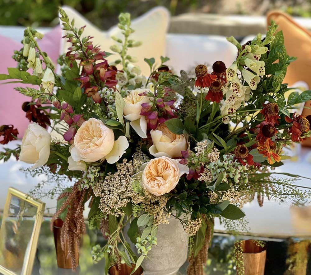 Decorative floral arrangement with various flowers on a table.