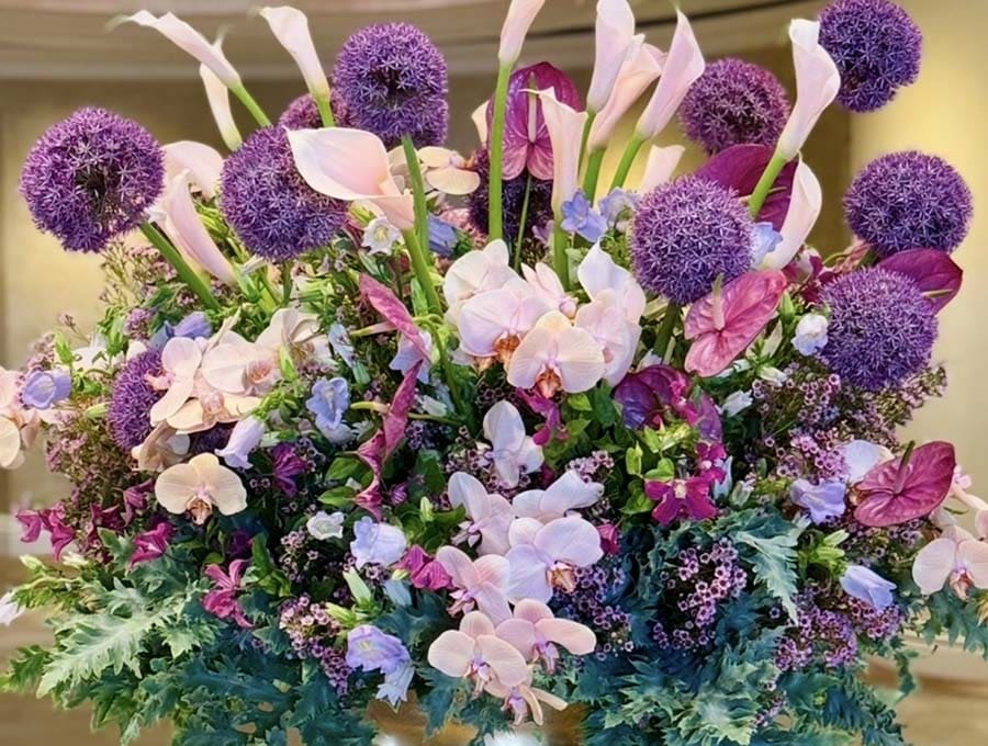 Colorful flower arrangement with purple and pink flowers in a vase.