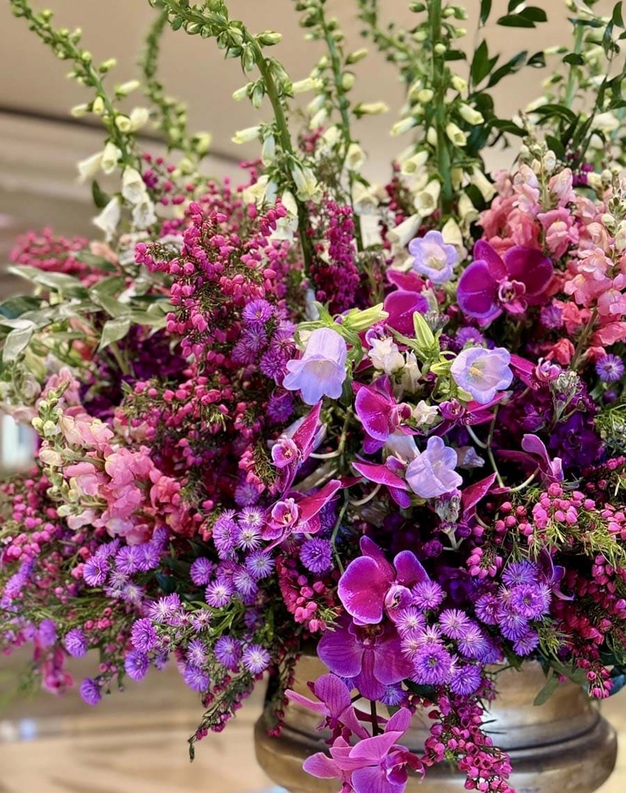 Bouquet of colorful flowers including pink, purple, and green in a vase.