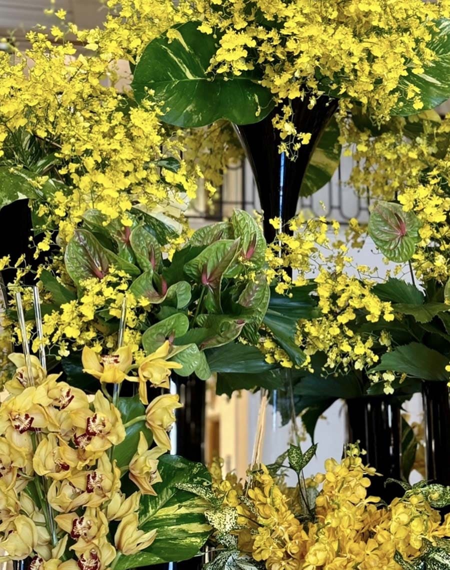 Bouquet of yellow flowers with green leaves in a decorative setting