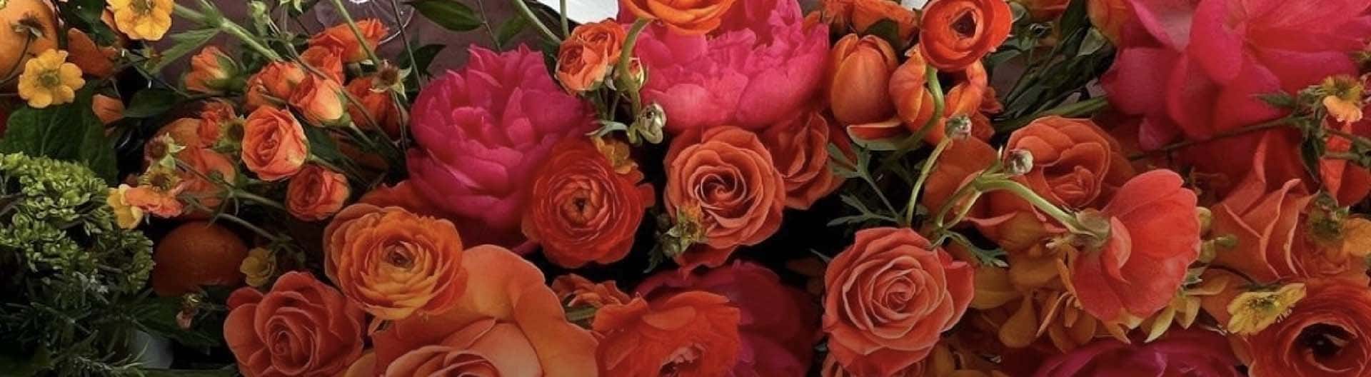 Bouquet of colorful flowers including oranges and pinks.