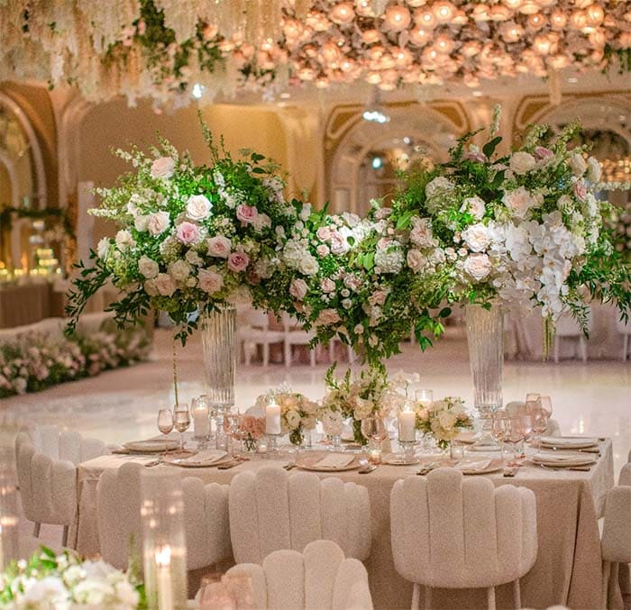 Decorative floral arrangement on a table with candles in an elegant indoor setting