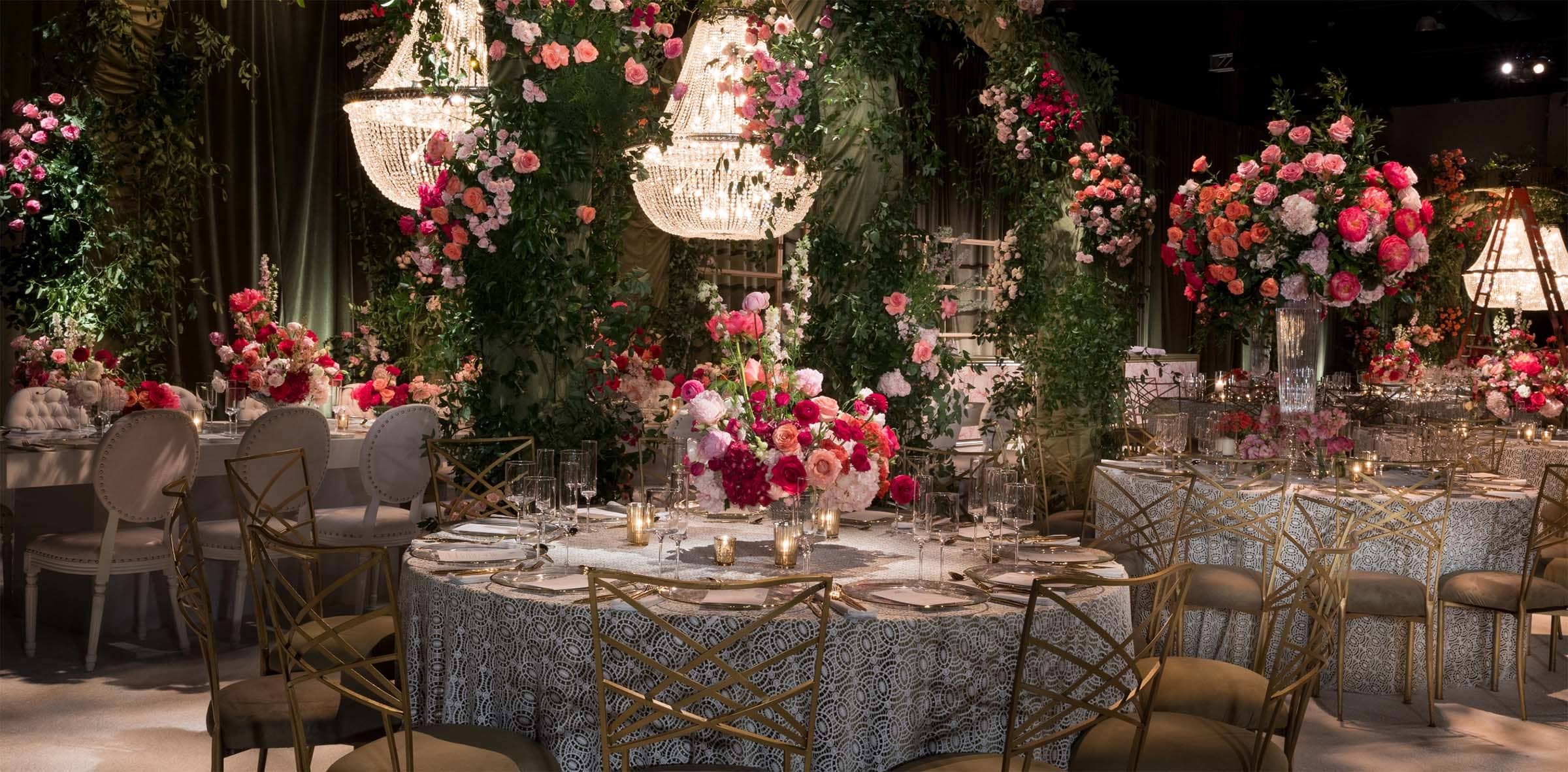 Decorative indoor setting with floral arrangements and table settings.